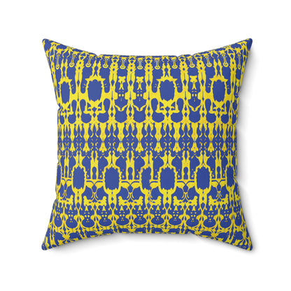 A square faux suede pillow with a bold, symmetrical pattern in yellow and blue. Intricate, interlocking shapes form a repeating abstract motif, giving this pillow a vibrant and modern appearance against the blue background with yellow detailing.