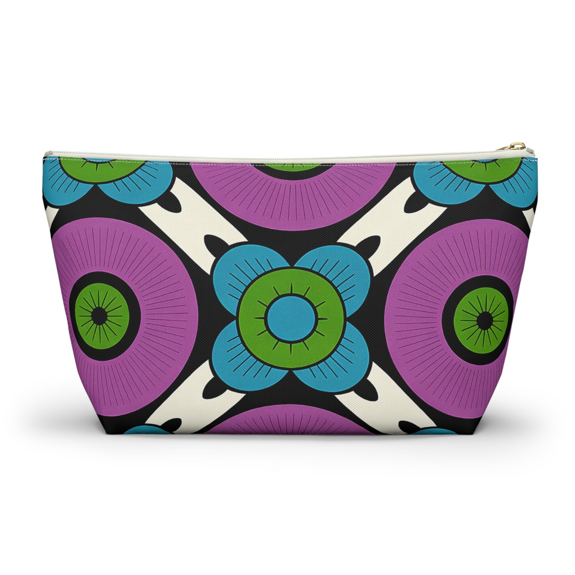 A cosmetic travel bag with a bold, colorful geometric floral pattern inspired by African patterns. Large purple circles, blue flowers with green centers, and black-and-white accents create a modern, symmetrical T-bottom pouch on a cream background.