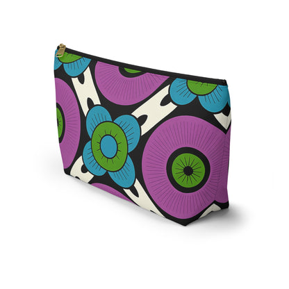 A zippered T-bottom pouch with a vibrant, retro floral pattern inspired by African-inspired patterns. Large purple and blue flowers with green centers pop against a white background. Features a gold zipper—perfect as a stylish cosmetic travel bag.