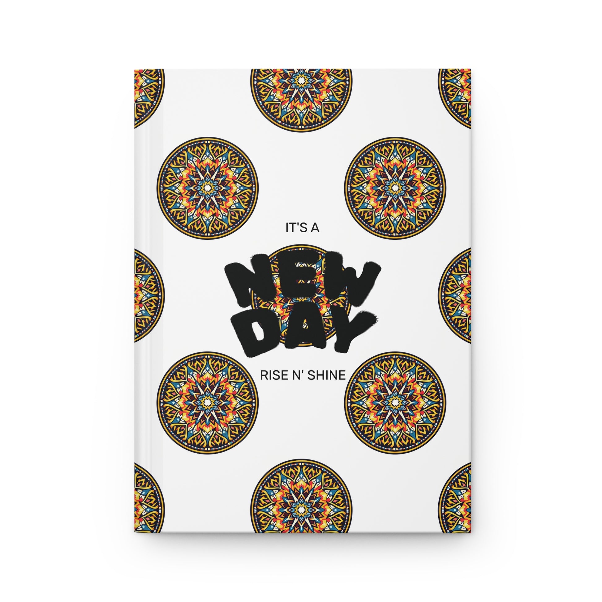 A durable writing journal, this notebook cover features intricate, colorful circular mandala patterns on a white background. In the center, bold black text reads NEW DAY, with smaller text above and below stating ITS A and RISE N SHINE.