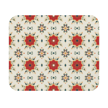 A repeating geometric pattern features red, orange, and green star-shaped motifs on a cream background. This African-inspired mouse pad is a creative desk accessory with layered points and a non-slip rubber base for added stability.