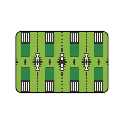 A rectangular Neoprene desk mat featuring a stylized green pattern resembling a football field, with white yard lines, black markings, arrows, chevrons, and geometric accents. Rounded edges and a black border make it an ergonomic desk mat for any workspace.