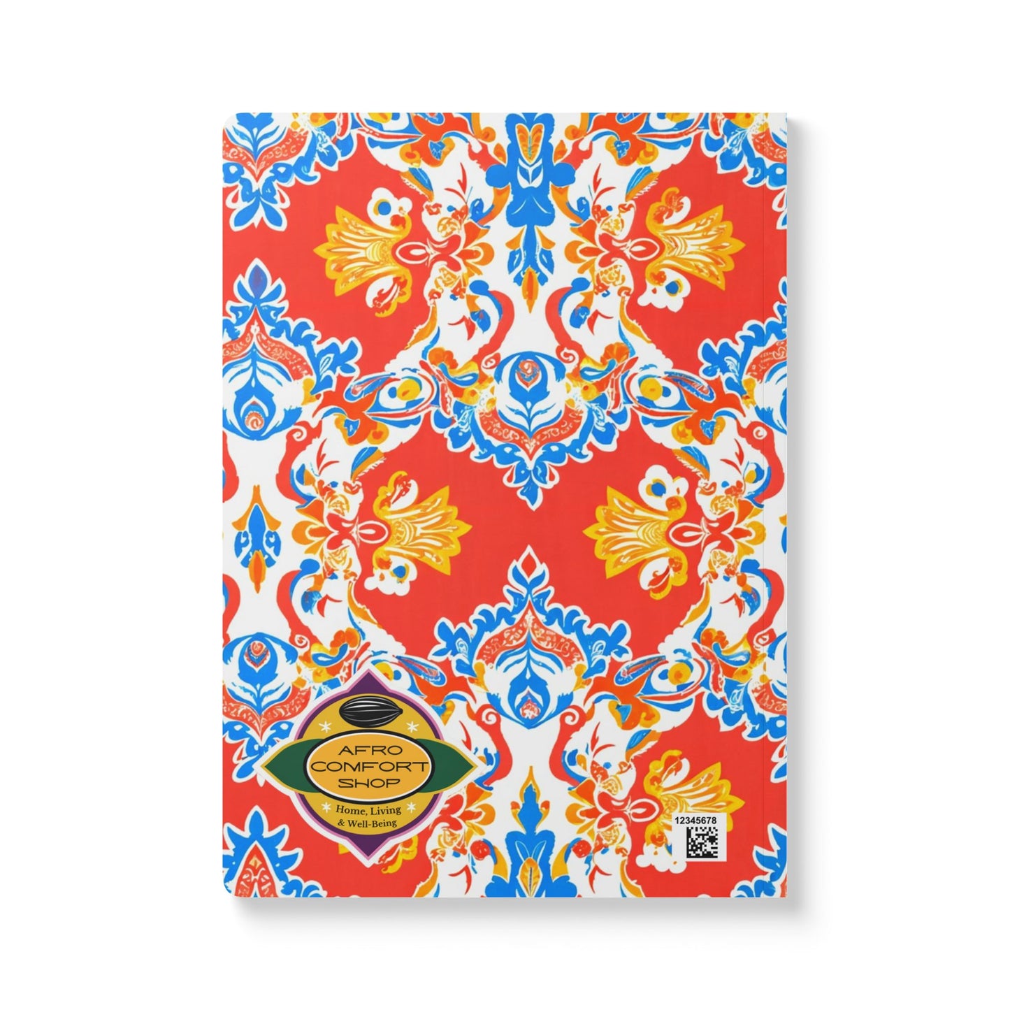 A vibrant African-inspired journal with a red cover featuring a symmetrical, ornate floral pattern in blue, yellow, and white. Ideal for daily journaling, it features a gold Afro Comfort Shop label and a QR code at the bottom right.