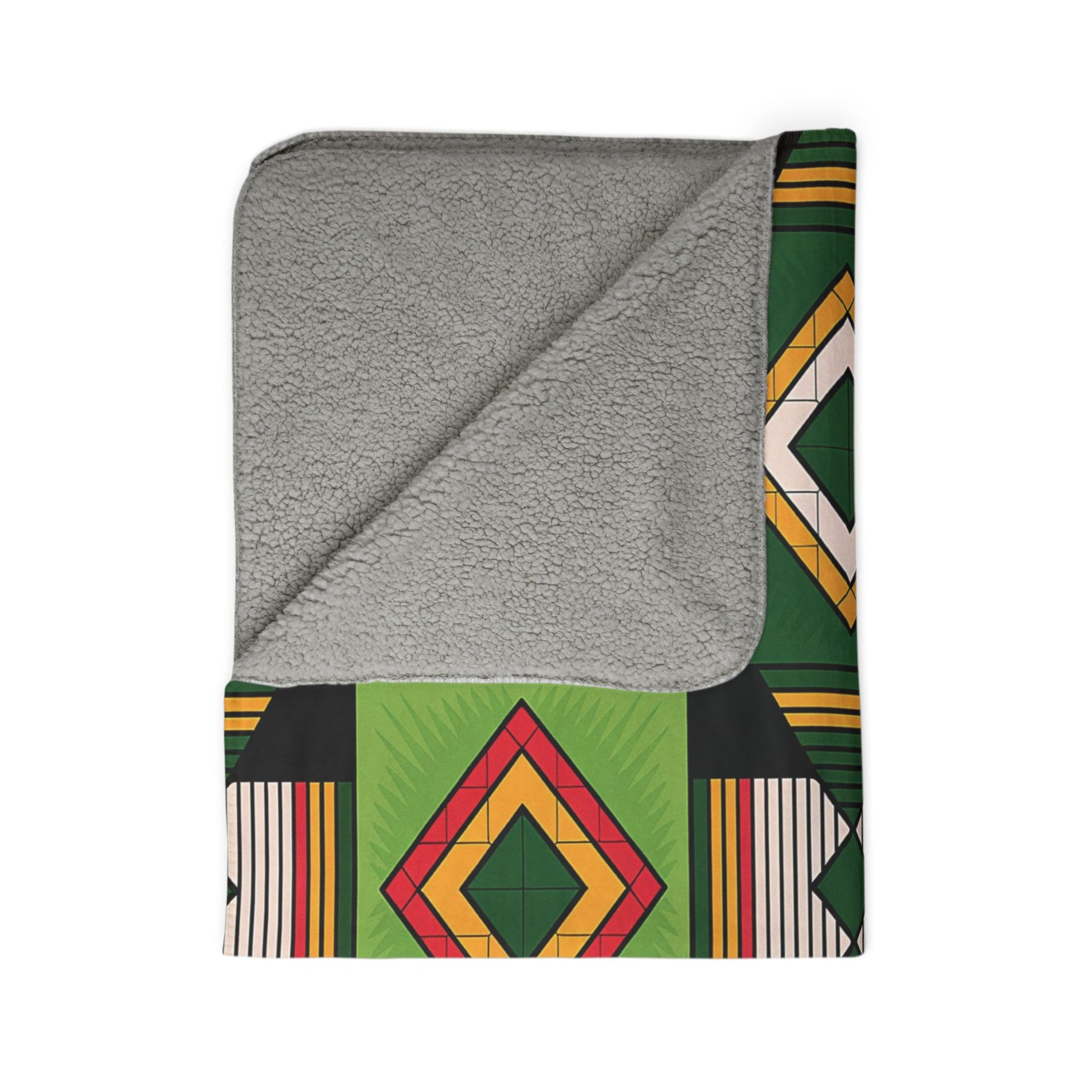A folded sherpa fleece blanket with a soft, gray sherpa lining. The outer side features African-inspired geometric patterns in red, yellow, and green on black, green, and cream stripes—perfect for cozy home decor. Corner turned to show the plush texture.