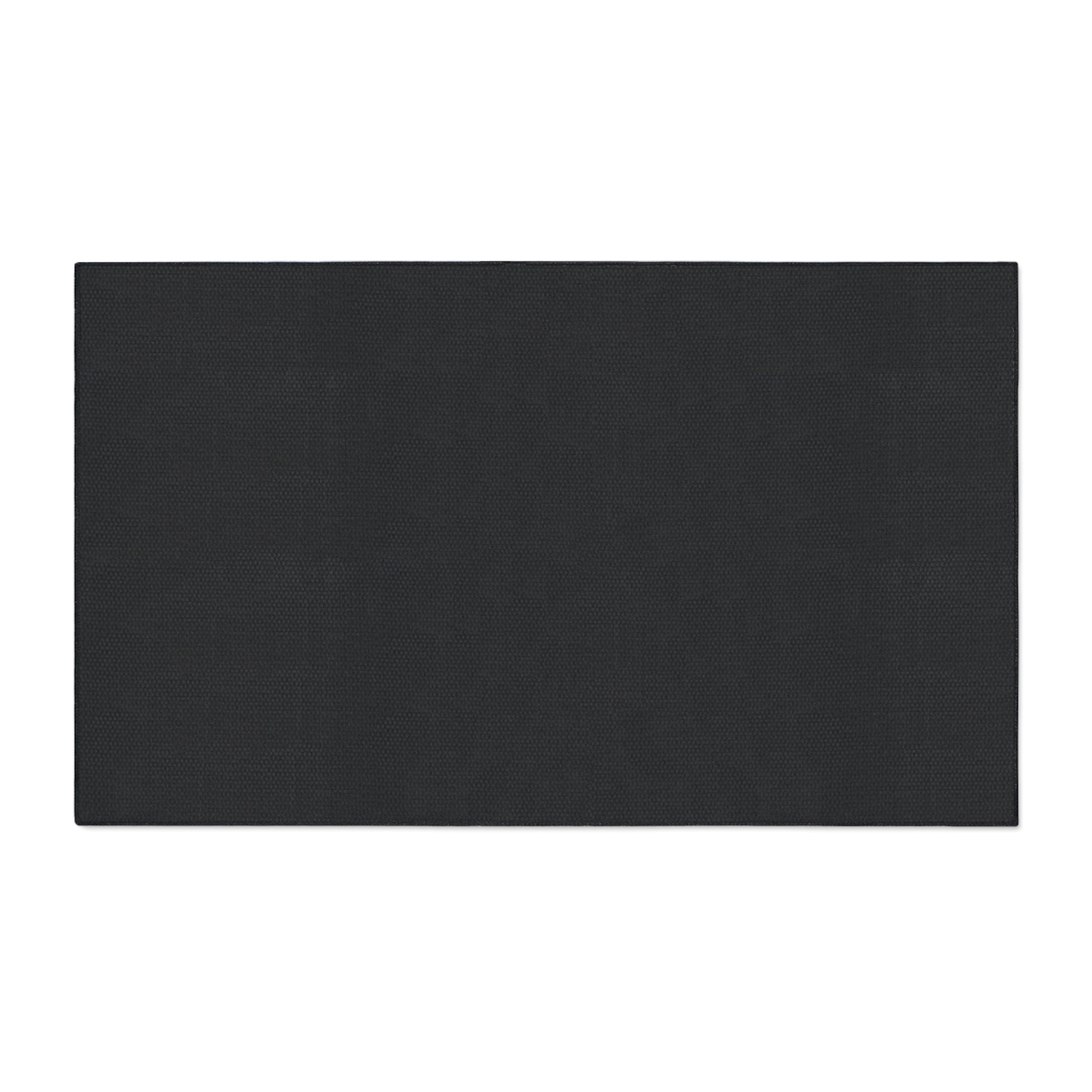 A large, rectangular black mat with a textured surface and non-slip rubber backing is centered on a white background. Its straight edges and minimalist design offer style and stability, featuring a consistent dark color with no visible logos or markings.