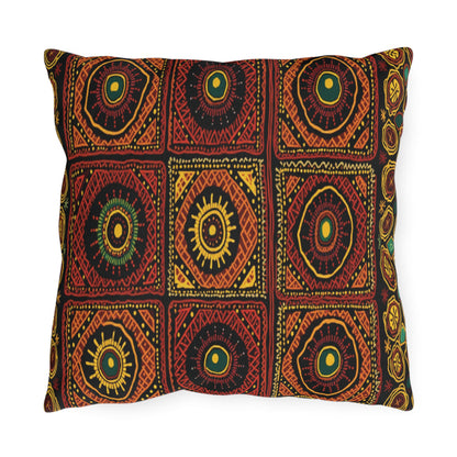 A rectangular pillow featuring a bold, African-inspired geometric pattern of concentric circles and sunburst shapes in red, yellow, green, and orange. Arranged symmetrically on black, the design evokes vivid traditional textile art.