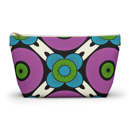A zippered T-bottom pouch with a bold, African-inspired geometric floral pattern. Large purple circles and blue, green-centered flowers stand out on a white background. Perfect as a cosmetic travel bag, it features a gold-colored zipper.
