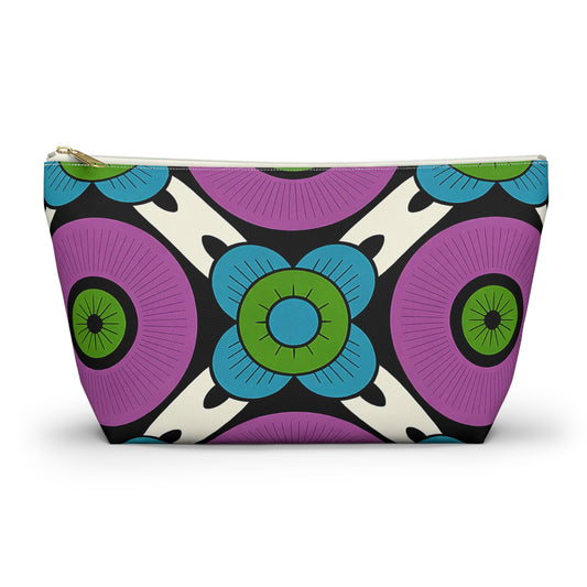 A zippered T-bottom pouch with a bold, African-inspired geometric floral pattern. Large purple circles and blue, green-centered flowers stand out on a white background. Perfect as a cosmetic travel bag, it features a gold-colored zipper.
