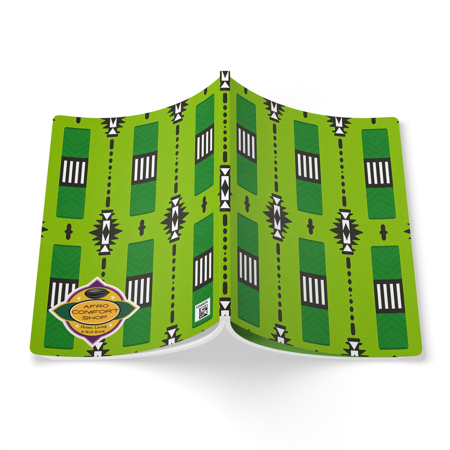 An open African-inspired journal with a bright green cover featuring geometric black, white, and dark green patterns. There’s an orange and yellow "Afro Comfort Edition" sticker on the bottom left. The symmetrical cover is vibrant and perfect for creative journaling.
