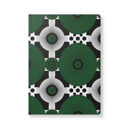 A creative journal with a cover featuring a geometric pattern of large green circles and radiating lines, intersected by white circles with black dots on a black background. This African-inspired journal offers a bold, modern, and symmetrical look.