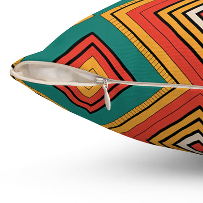 Close-up of an African-Inspired pillow with a visible white zipper. The fabric displays vibrant patterns of concentric squares in red, yellow, orange, black, and green on a white background, making it a striking piece for home decor.