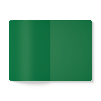 An open African-inspired journal lies flat on a white surface, displaying two blank, solid green pages with no writing, lines, or designs. The notebook appears to have rounded corners and a smooth texture, perfect for creative journaling.