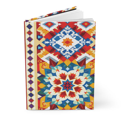 A hardcover journal with a colorful, rainbow geometric design on the cover, featuring interlocking shapes in red, blue, yellow, and white. Symmetrical starburst and diamond motifs create a vibrant, mosaic-like appearance. The book is partly open.