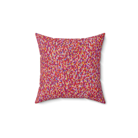 A square faux suede pillow with a dense, colorful floral pattern. The fabric features small flowers in red, pink, yellow, white, and blue for a vibrant look. This African accent pillow is centered on a plain white background.