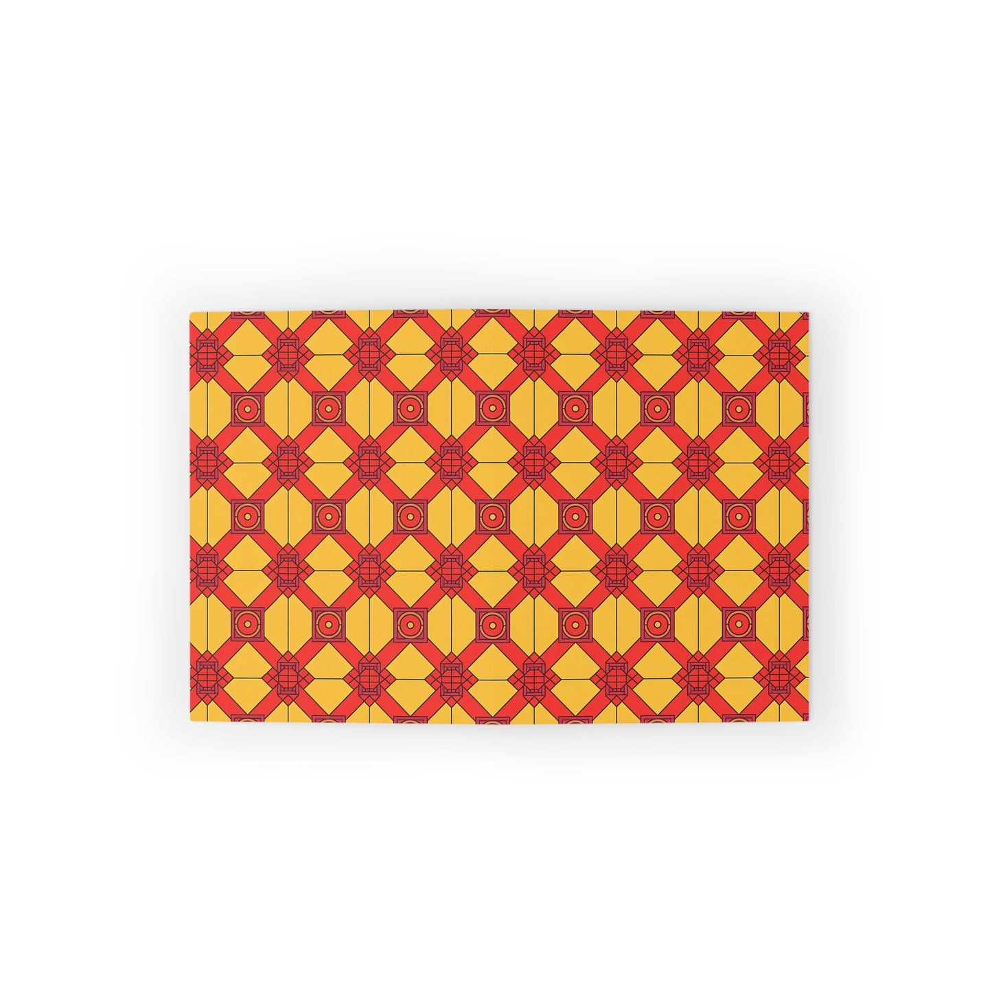 Rectangular mat with a repeating geometric pattern of red and orange diamond shapes and circles on a yellow background. The culturally inspired design creates a vibrant, symmetrical effect, reminiscent of African-inspired greeting cards.