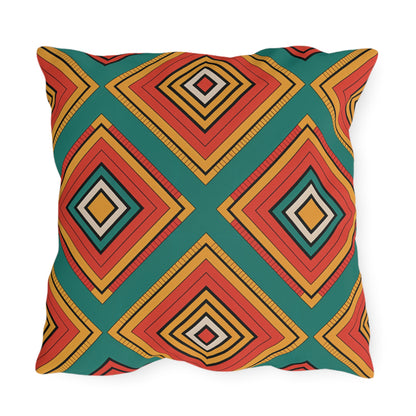 A square pillow featuring a colorful geometric pattern with diamond shapes on a green background. Crafted from weatherproof materials, this bold and vibrant outdoor pillow is perfect for adding an eye-catching touch to your patio or garden.