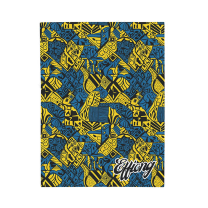 A rectangular notebook cover with an intricate blue and yellow geometric pattern, featuring stylized African-inspired shapes and motifs—echoing the vibrant designs of an African-inspired blanket. The lower right corner displays Effiong in bold, cursive white font.