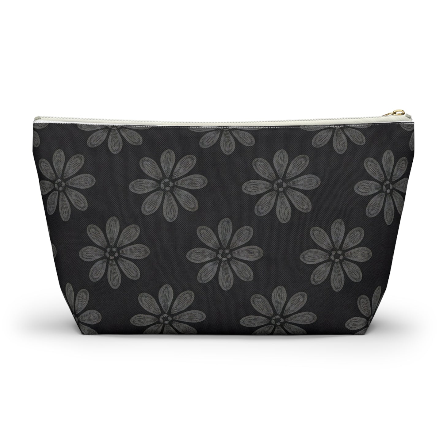 A zippered cosmetic travel bag with a black background, decorated with a repeating pattern of large, hand-drawn, gray daisy-like flowers. This T-bottom pouch tapers towards the base and features a white zipper and gold zipper pull.