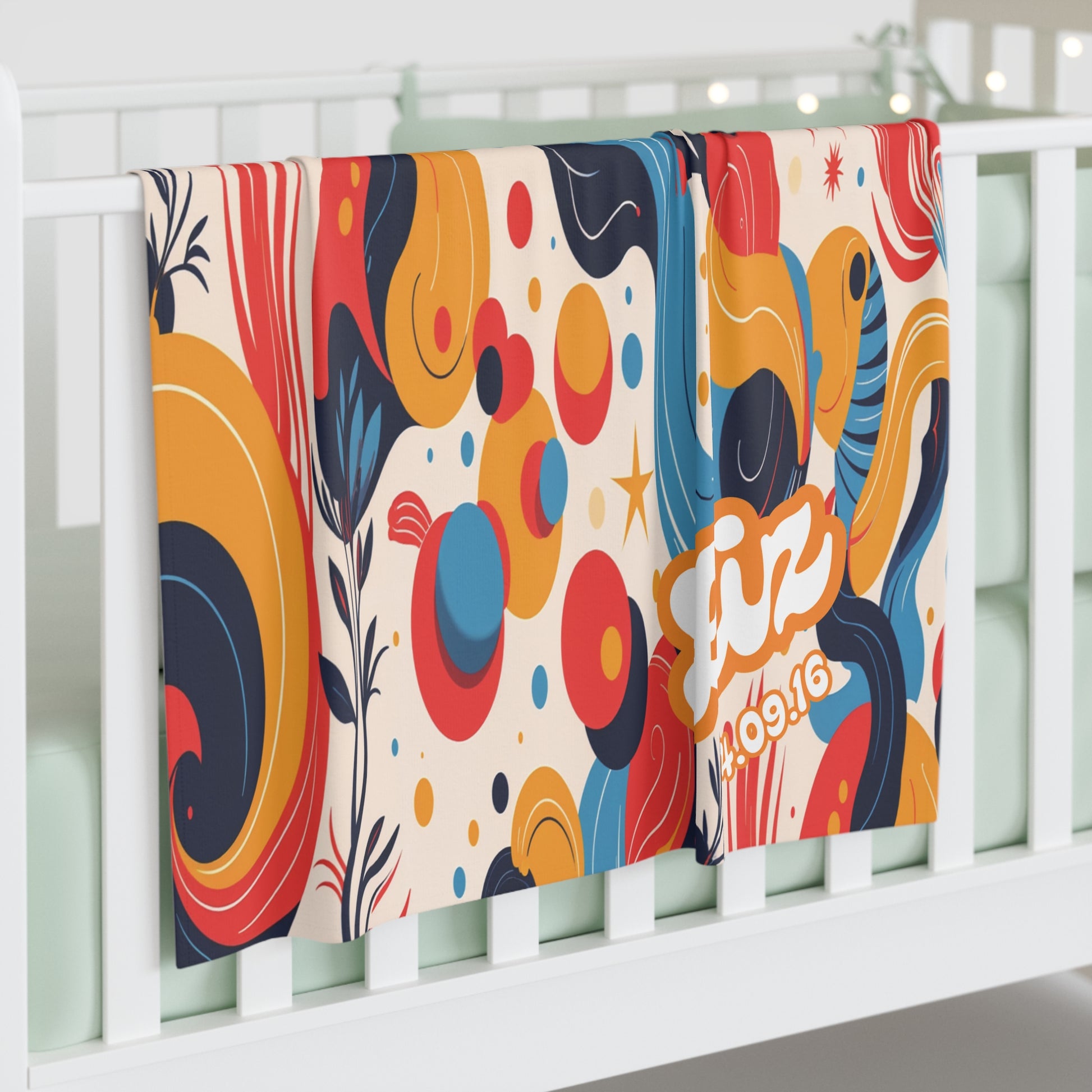 Two colorful personalized baby blankets hang over a white crib rail. Featuring abstract, retro designs and vibrant colors, these cozy blankets add a playful touch and a hint of African-inspired decor to any nursery. One displays “Liz” and the date 10.9.16 in bold lettering.