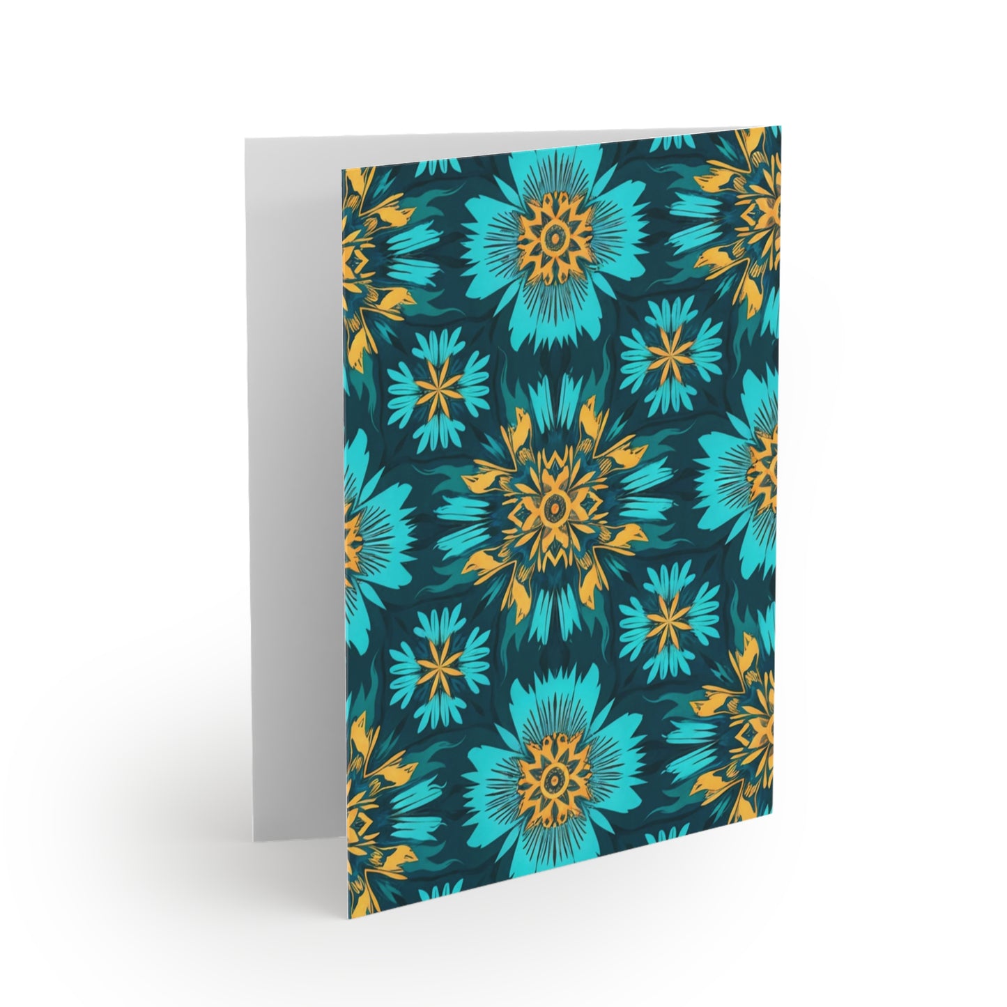 A greeting card stands open with a vibrant floral pattern on the front, inspired by African-inspired greeting cards. Blue and teal flowers with yellow and orange centers stand out against a dark background; the inside is blank and white.
