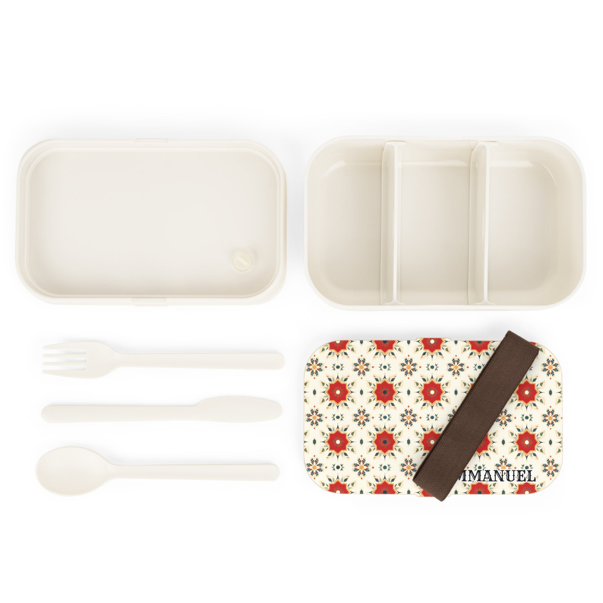 A personalized bento lunch box set with a floral-patterned lid, “IMANUEL” text, and brown elastic band. This custom lunch box includes a divided main compartment, plain white lid, and three utensils: fork, knife, and spoon.