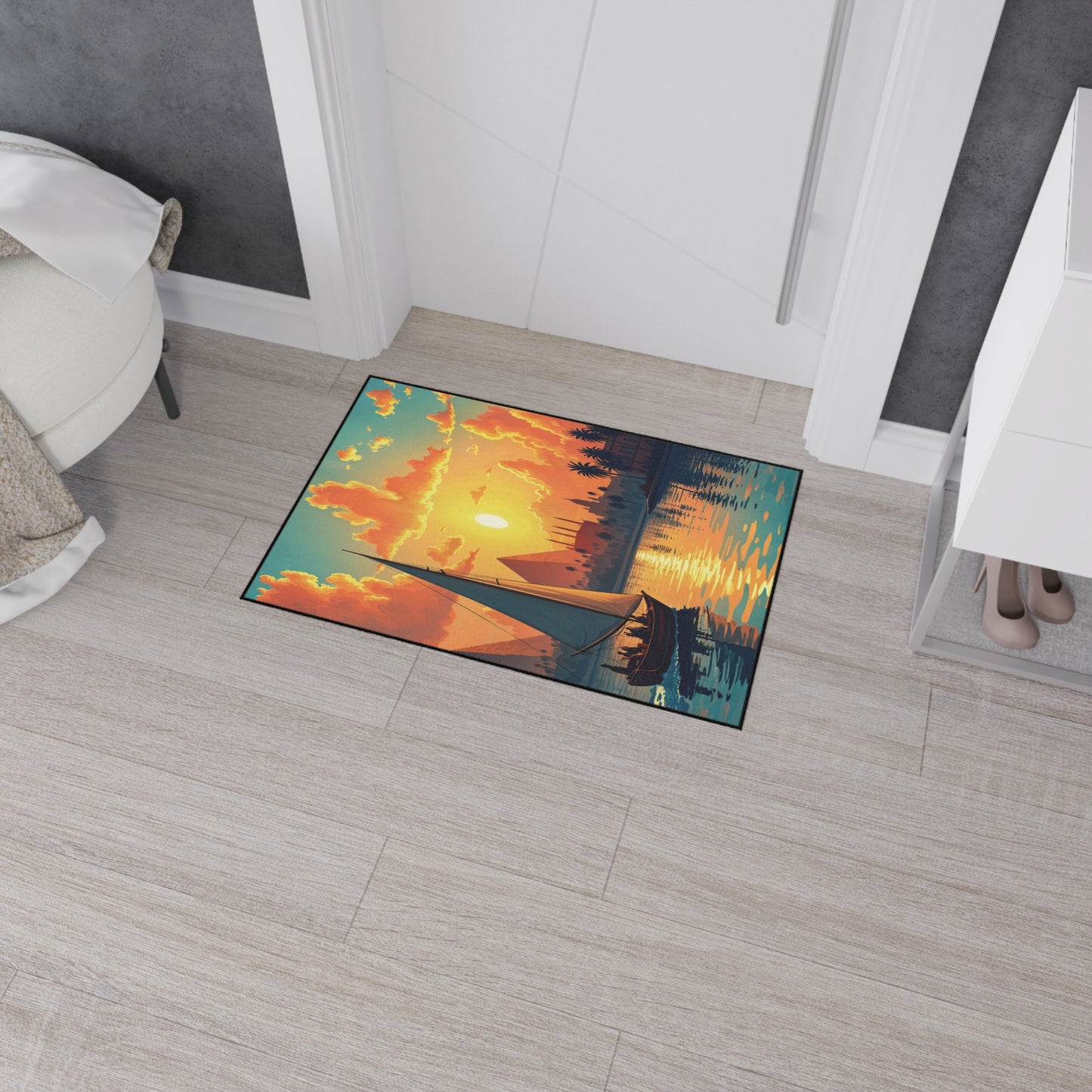 A rectangular custom floor mat near a doorway features a vibrant illustration of a sunset over a lake, with an orange sky, clouds, silhouetted trees, and a boat. Its non-slip rubber backing suits light wooden floors and modern African-inspired home decor.