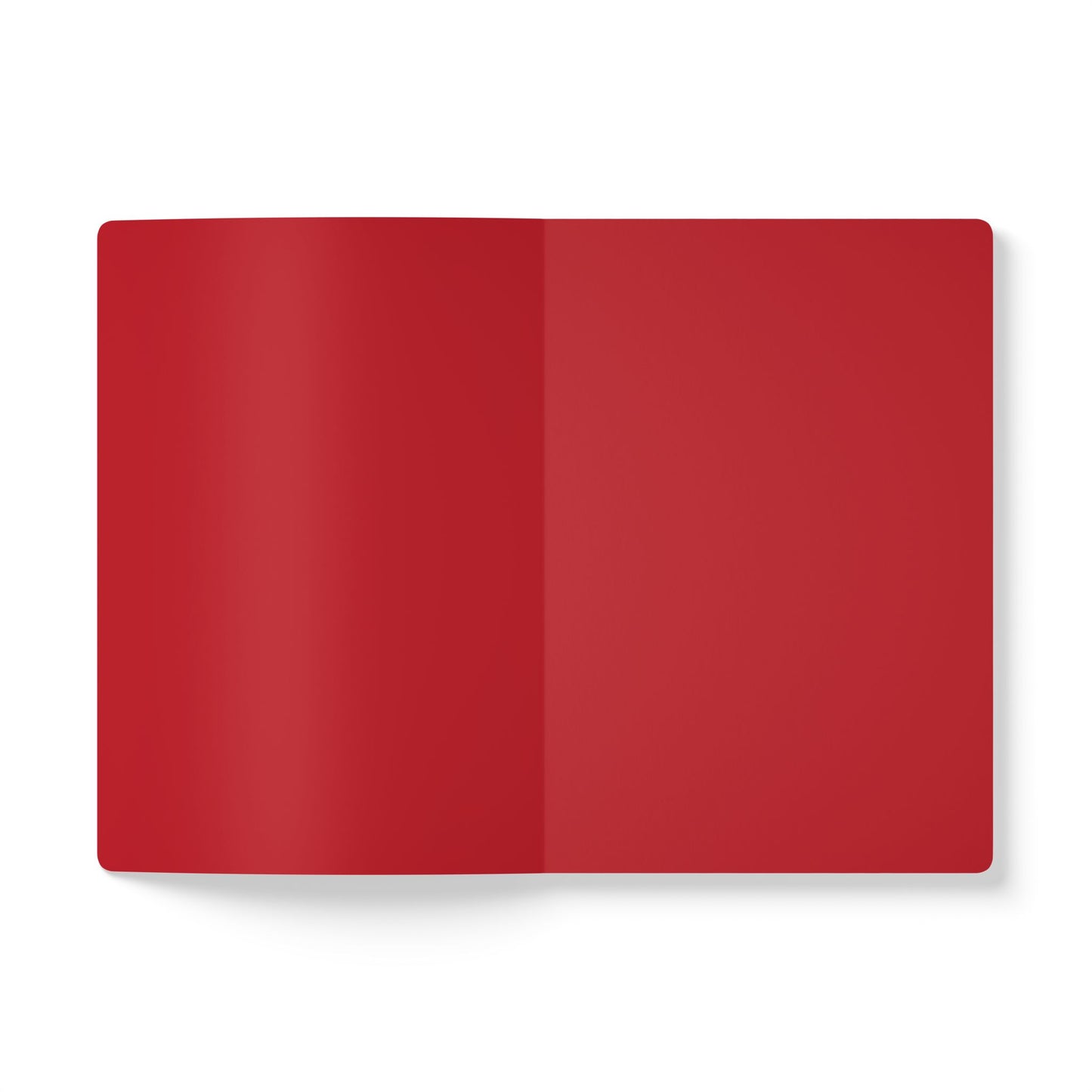 An open African-inspired journal with blank red pages lies flat on a white background. Both the left and right pages are solid red, ideal for creative journaling, with a soft shadow adding depth and dimension.
