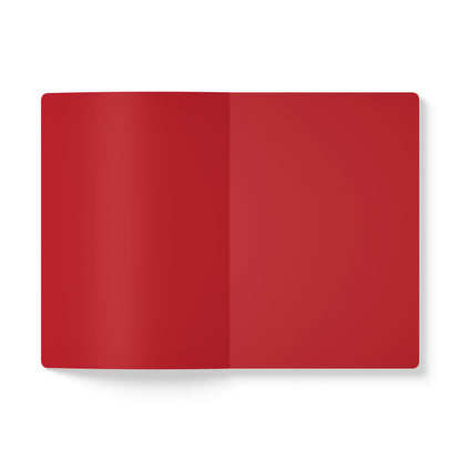 An open African-inspired journal with blank red pages lies flat on a white background. Both the left and right pages are solid red, ideal for creative journaling, with a soft shadow adding depth and dimension.