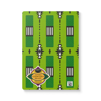 A creative notebook with a bright green cover, bold geometric African-inspired pattern, and diamond-shaped label with AFRO COMFORT SHOP and a QR code—perfect for daily journaling or use as your go-to African-inspired journal.