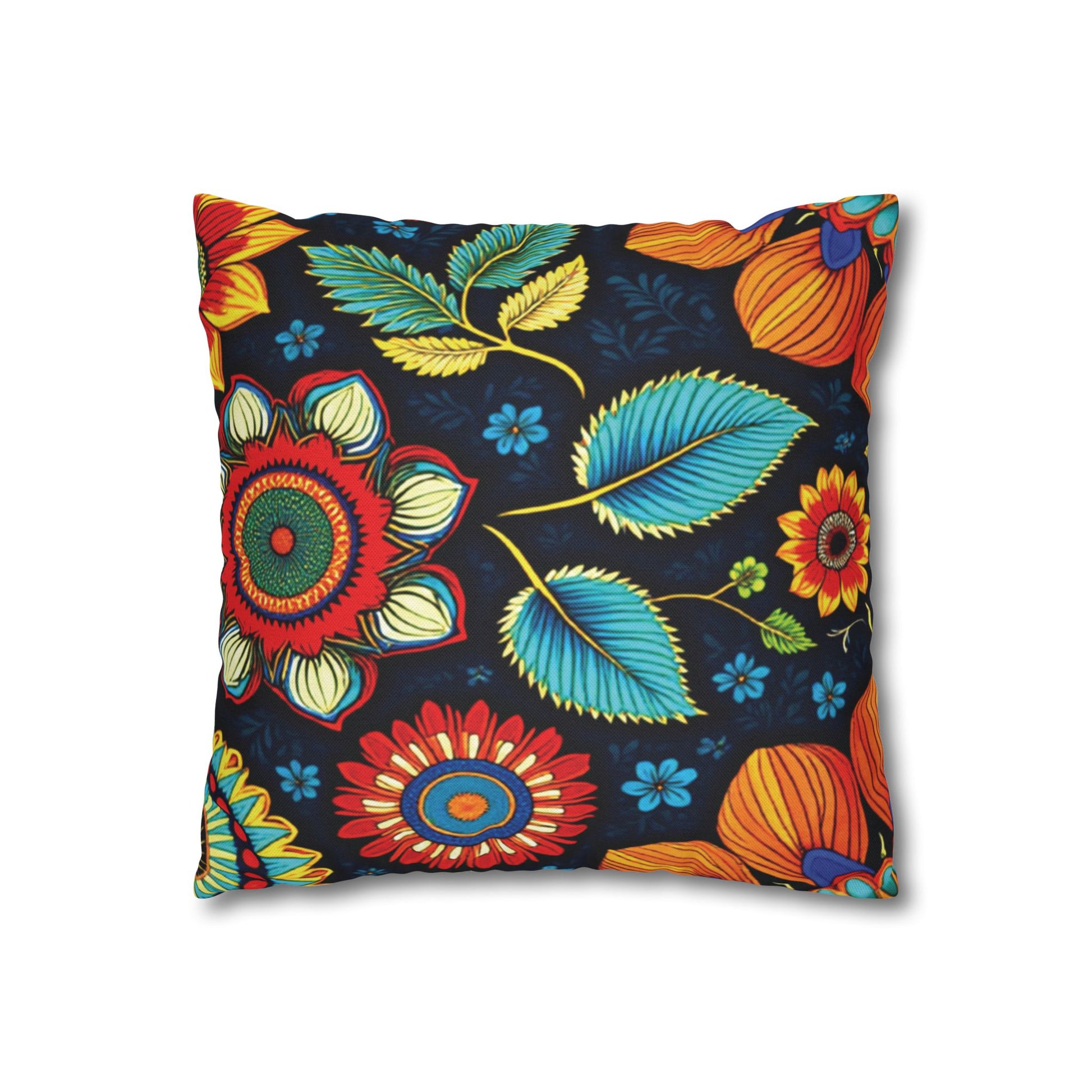A square pillow featuring a bold, colorful floral pattern inspired by African pillowcases, with large red, orange, and yellow flowers, blue leaves, and small blue flowers on a dark navy background in a vibrant, folk-art style.