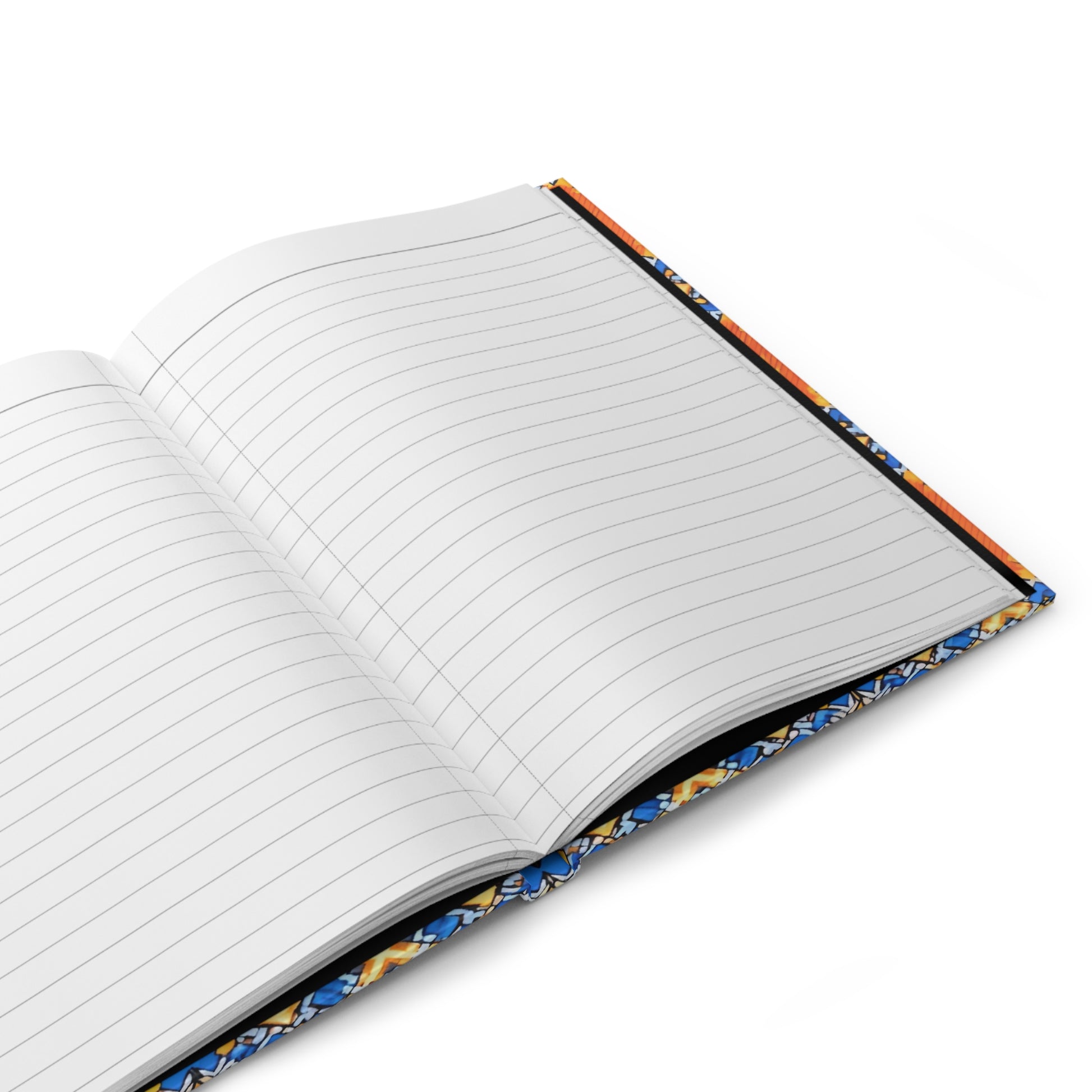 An open, lined hardcover notebook with a colorful sunburst design—blue, orange, and white—rests diagonally on a white background. The pages are blank and the vibrant cover evokes an African-inspired journal style.