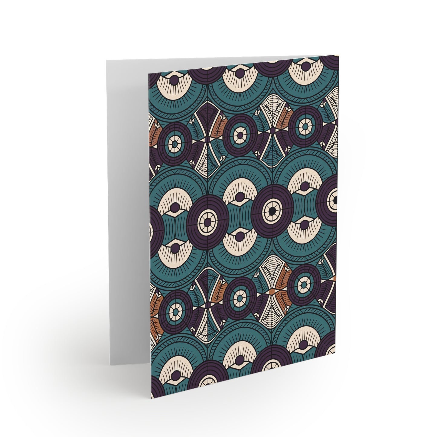 A greeting card stands upright, featuring an intricate pattern of overlapping teal, cream, and brown circular and geometric shapes with fine lines and dots—a beautiful example of premium stationery with a culturally inspired design. The background is white.