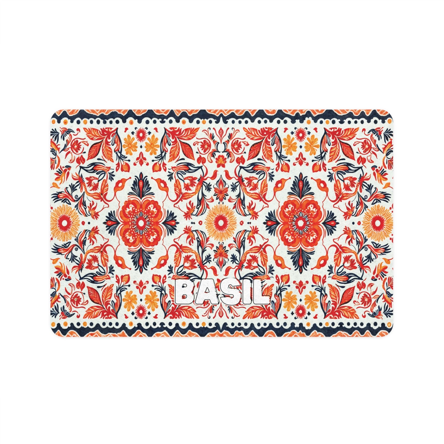 A colorful rectangular mat with a repeating African-inspired floral pattern in red, orange, navy blue, and black on a white background. Large flowers and leaves are prominent, and BASIL is written in bold white letters in the center.