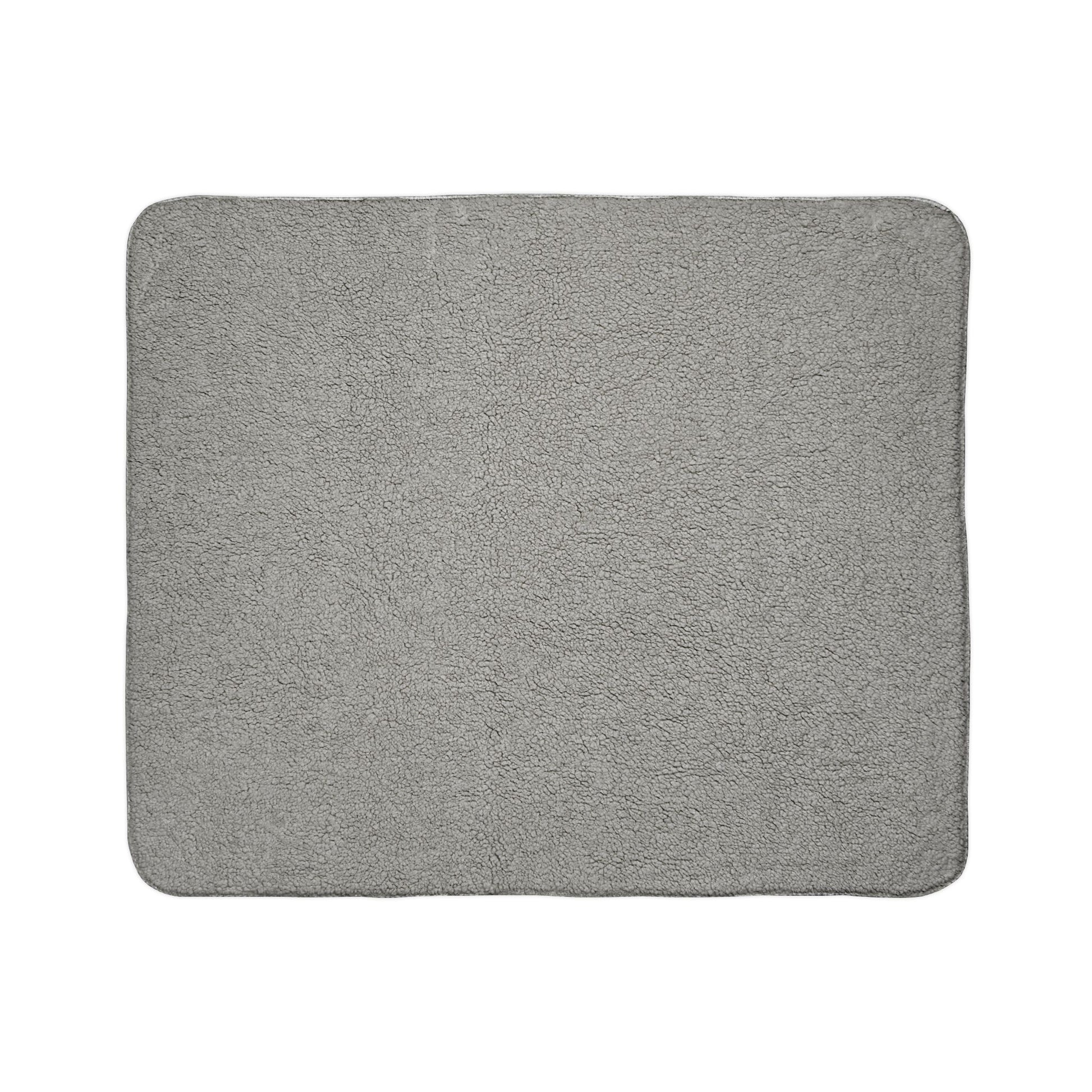 A rectangular, light gray bath mat with rounded corners. The soft, fluffy surface resembles sherpa fleece, adding plush comfort to your home decor. Photographed against a plain white background, its absorbent texture and simple design stand out.