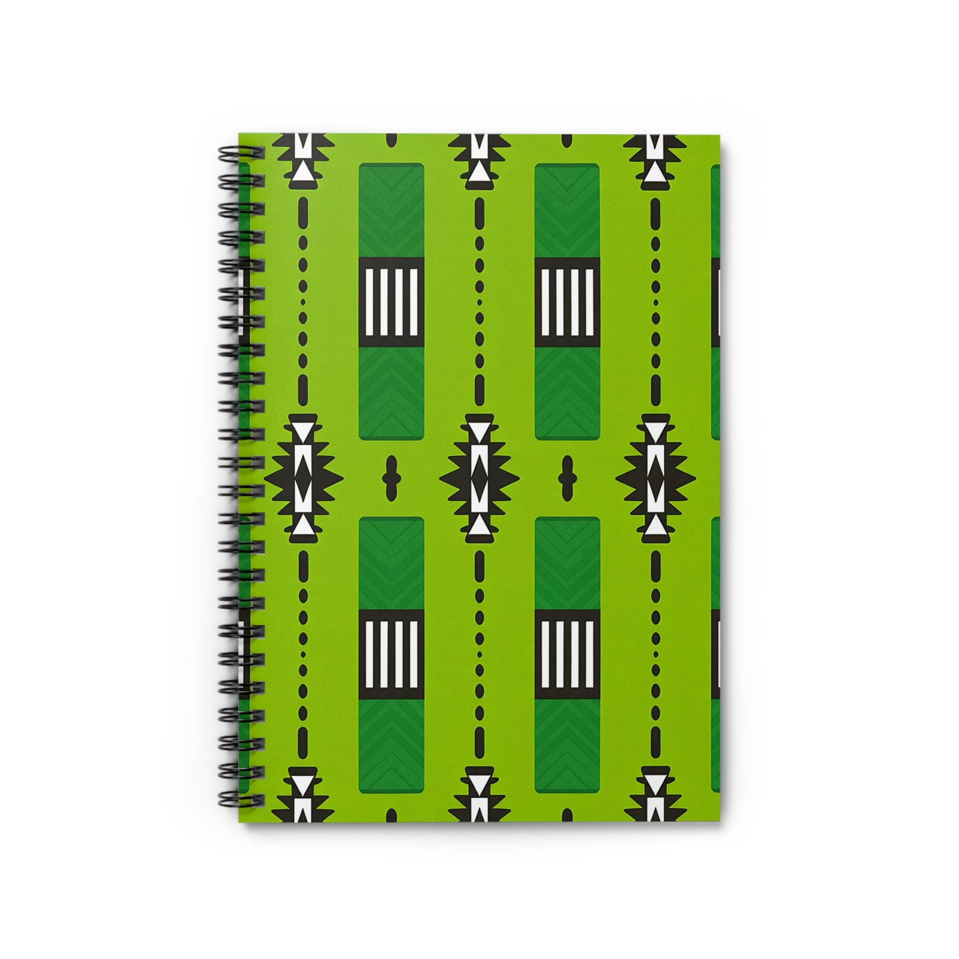 A green spiral notebook with a bold geometric cover inspired by African pattern notebook designs—vertical rectangles, black and white triangles, small circles, and dot lines arranged symmetrically with black, white, and dark green accents.