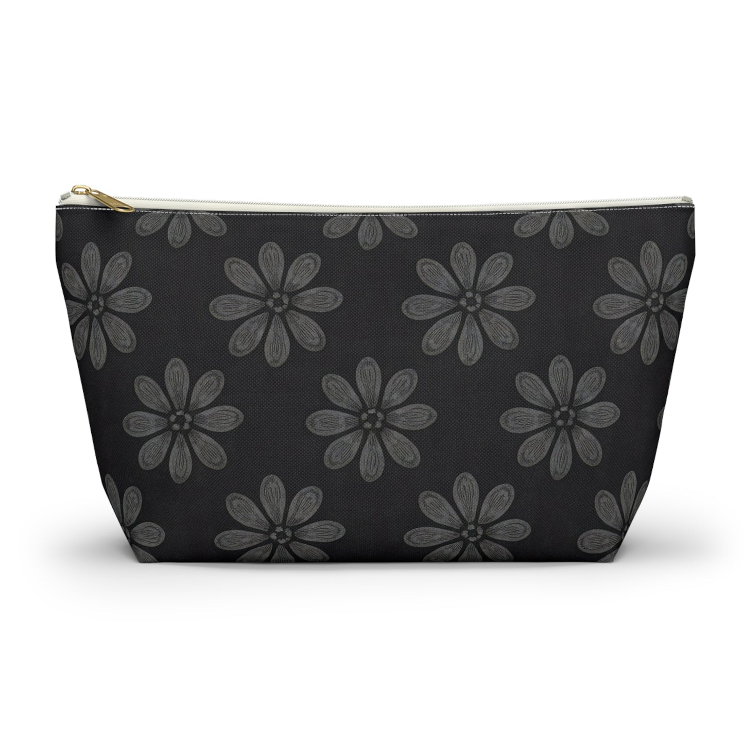 A medium-sized T-bottom pouch featuring a bold, African-inspired pattern of large gray six-petaled flowers on solid black. With a gold zipper and white trim, this chic cosmetic travel bag is displayed elegantly on a white surface.