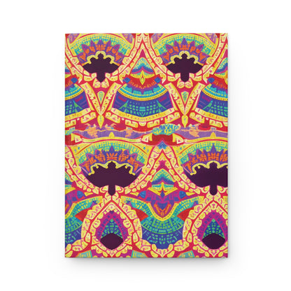 A hardcover journal showcases a vibrant, symmetrical pattern with repeating shapes in red, yellow, purple, blue, and green. The African-inspired design resembles ornate kaleidoscopic arches and fans on a white background for an eye-catching effect.