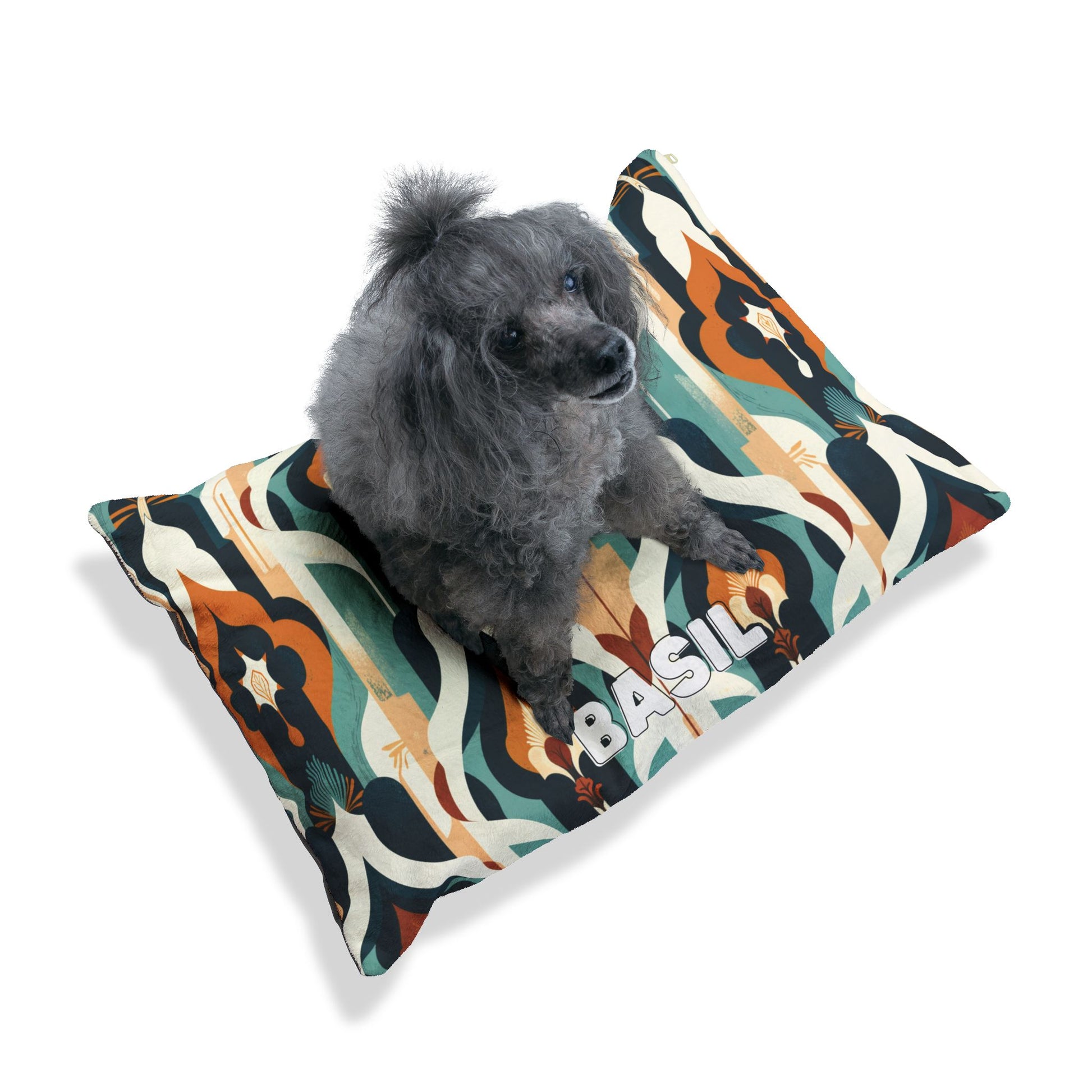 A gray poodle sits on a cozy, personalized pet bed featuring durable construction and a bold mix of teal, orange, black, and cream wavy patterns. BASIL is printed in white letters near the edge. The background is plain white.