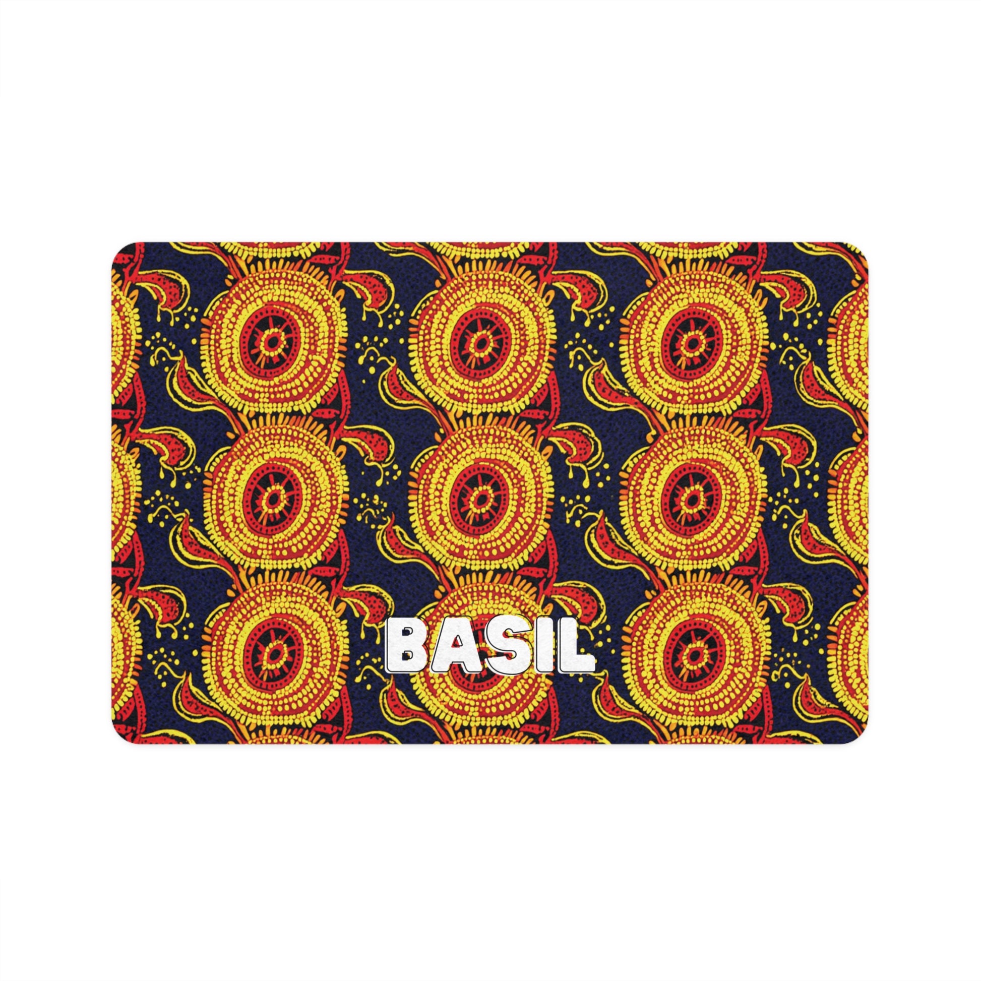 A rectangular card with a vibrant, African-inspired pattern of yellow and red circular shapes on a dark background. The circles feature intricate dotted and radiating line details. “BASIL” appears in bold, white, uppercase letters at the bottom center.