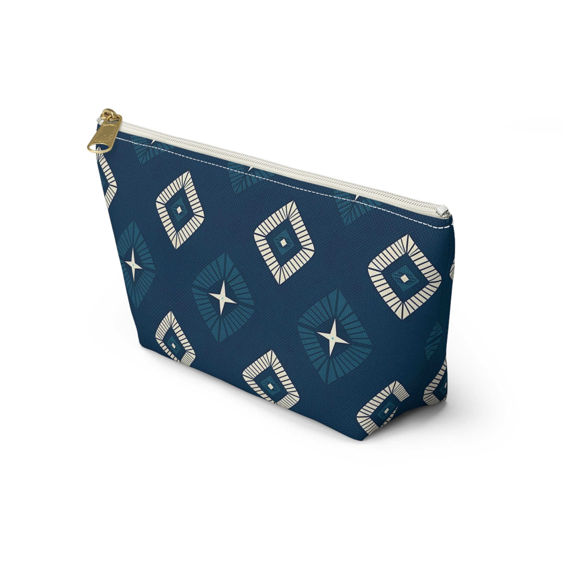 A blue T-bottom pouch with a gold zipper pull, featuring an African-inspired pattern of white and blue diamonds and star shapes. This cosmetic travel bag stands upright on a white background.