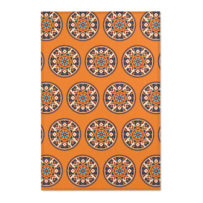 Rectangular orange rug with a repeating pattern of African-inspired circular medallions. Each medallion boasts intricate geometric and floral motifs in navy, teal, cream, and coral, evenly spaced across the entire surface.