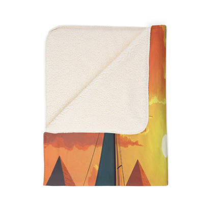 A folded African-inspired fleece blanket with a soft, cream-colored sherpa lining. The printed side shows a vivid sunset scene with orange clouds, a yellow sky, Egyptian pyramids, and the tip of a tall, dark blue obelisk—perfect for stylish home decor.