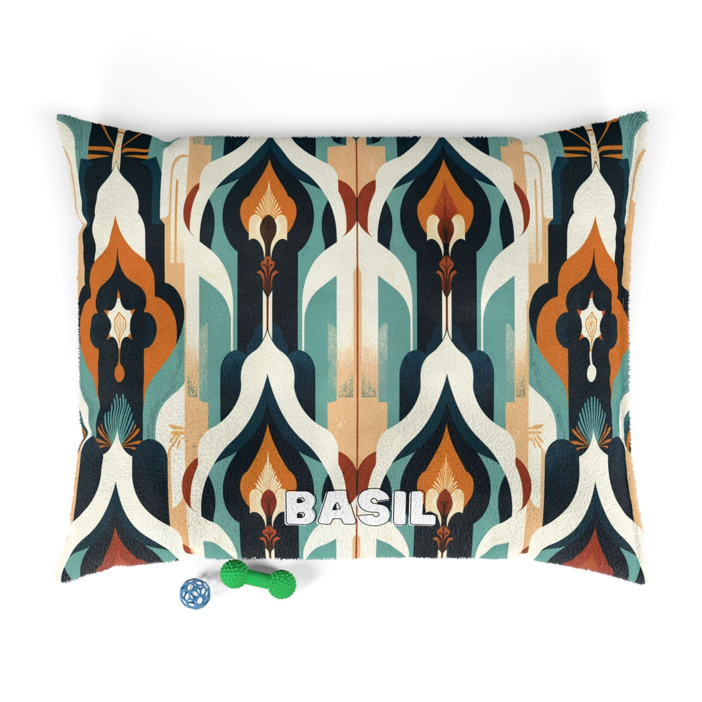 A cozy pet bed with durable construction, featuring a geometric art deco pattern in teal, cream, orange, and navy. The name BASIL is boldly printed in white at the center. In front are a green chew toy and a blue-and-white ball.