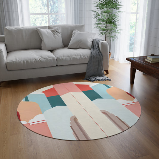 A modern living room with a light gray sofa, white curtains, and a large plant. On the wooden floor is an African round rug featuring vibrant patterns in durable polyester chenille. A dark wooden table sits on the right, and a gray blanket drapes over the sofa arm.