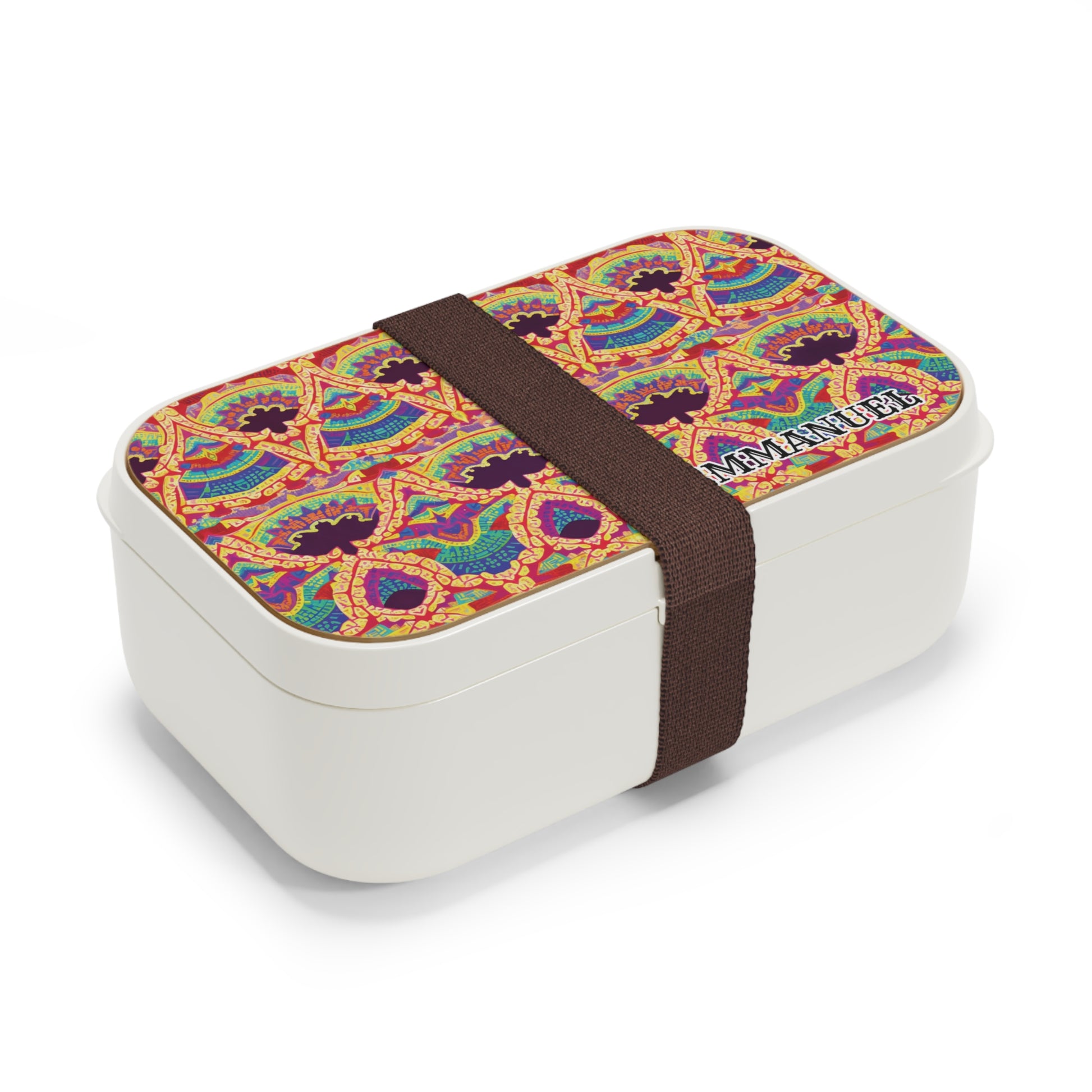 A rectangular white African-inspired lunch box with a colorful, intricate geometric pattern on the lid, secured by a wide dark brown elastic band. The lid also features the text AMANOUR in the corner.