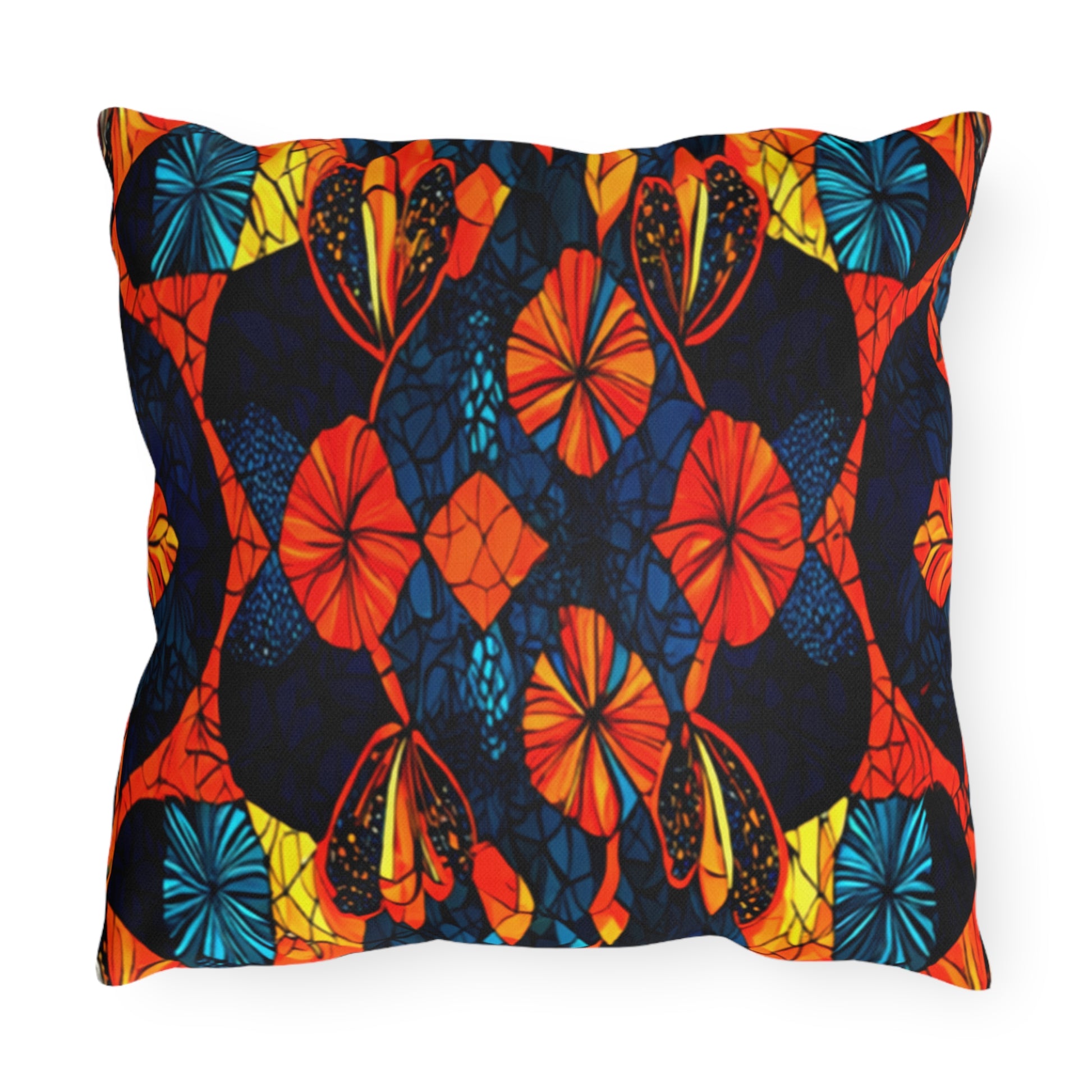 A square outdoor pillow with a vibrant, symmetrical abstract pattern in orange, red, yellow, blue, and black. The water-resistant design features floral and leaf-like shapes for a stained glass effect with bold colors and intricate lines.