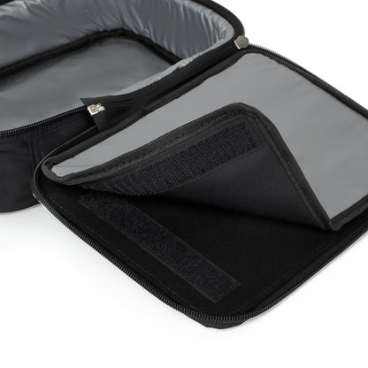 Close-up of an open black insulated lunch bag with a grey interior. This versatile African-inspired lunch tote features a zipper closure and Velcro flap, revealing two compartments that keep your food items separated and secure.