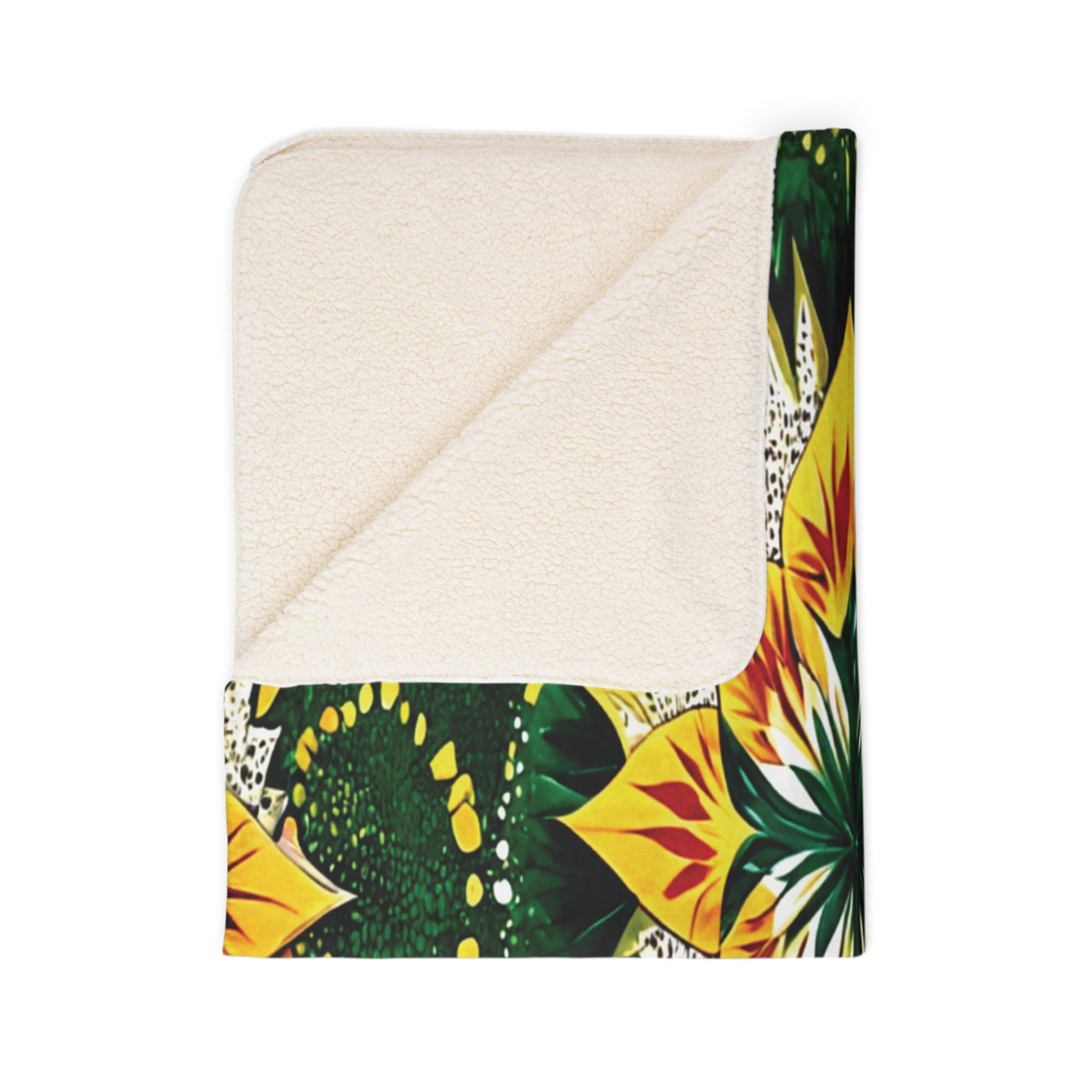 A square blanket, perfect for home decor, is shown folded at one corner to reveal a soft sherpa fleece underside. The top side features a vibrant, multicolored floral pattern with green, yellow, and orange petals on a white background.