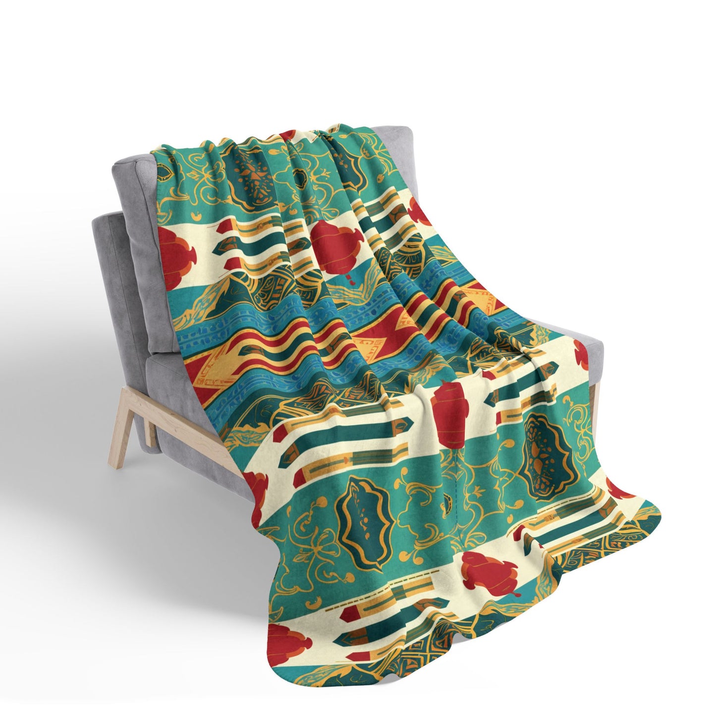 A colorful, African-Inspired patterned blanket drapes over a modern gray chair. Bold stripes, geometric shapes, red accents, and gold outlines on green, cream, and blue create an intricate, vibrant, and decorative design.