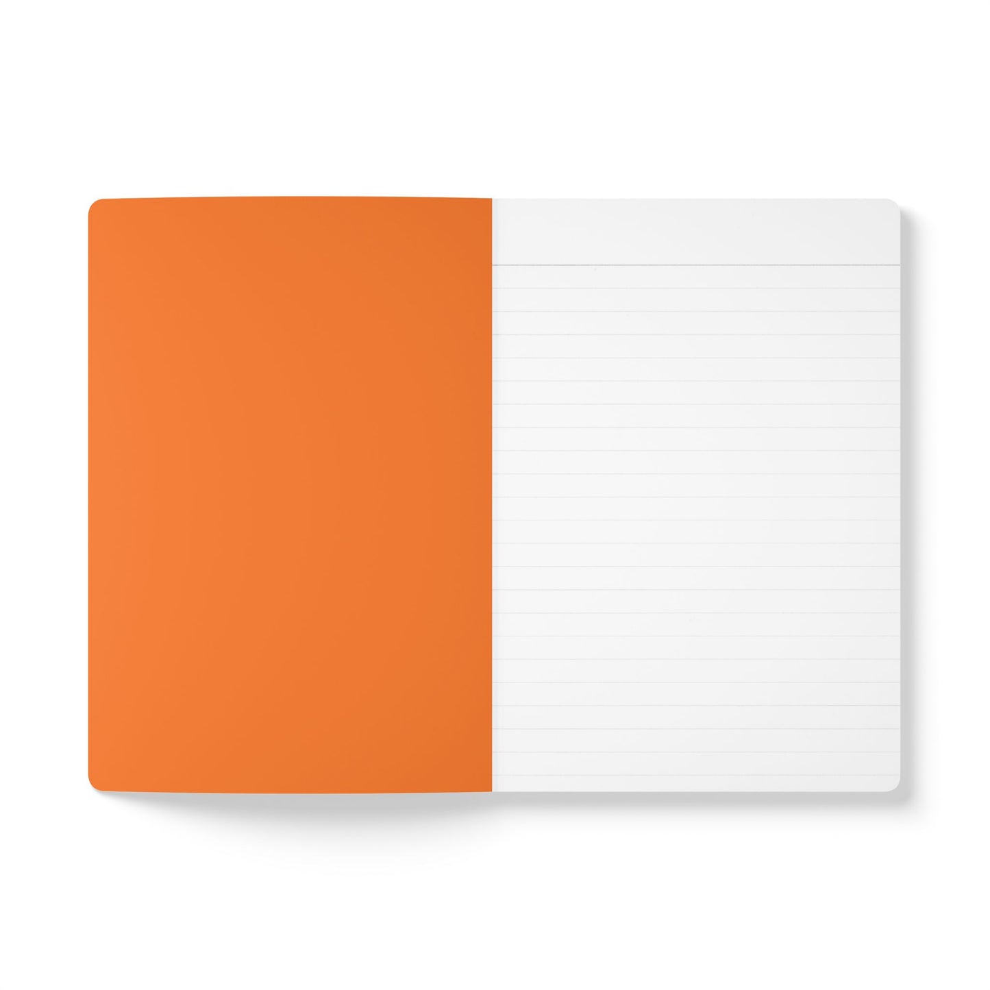 An open creative journal viewed from above; the left page is solid orange, while the right has light gray lines for daily journaling. The notebook rests on a white surface, maintaining a minimalistic and clean appearance.
